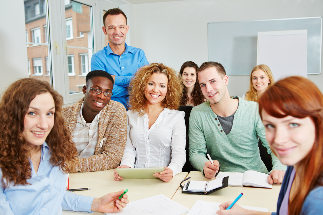 Teacher with Students in College Course